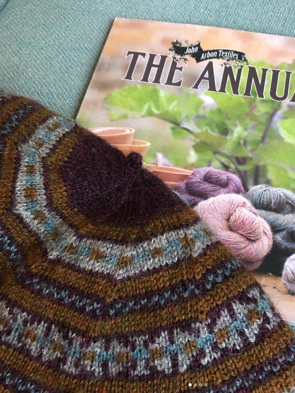 A colourwork beret in russet and purple tones.