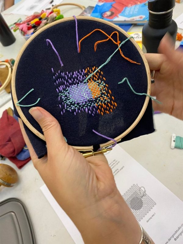 Darning in progress on an embroidery hoop