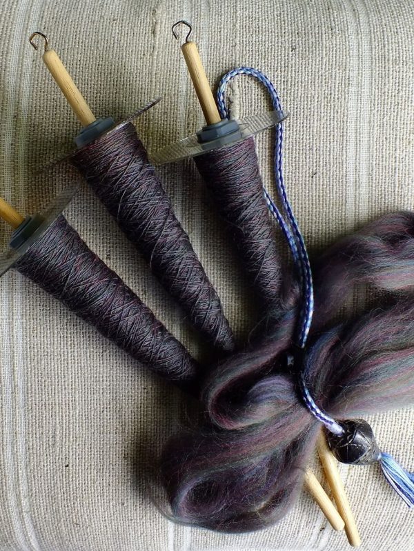 Three CD drop spindles filled with handspun singles