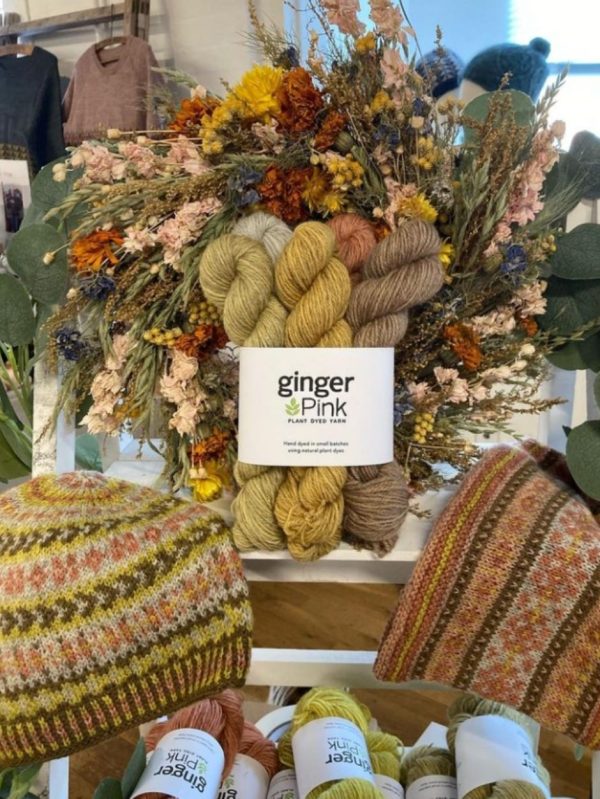 A gorgeous display of Ginger Pink skeins and patterns knitted in them.